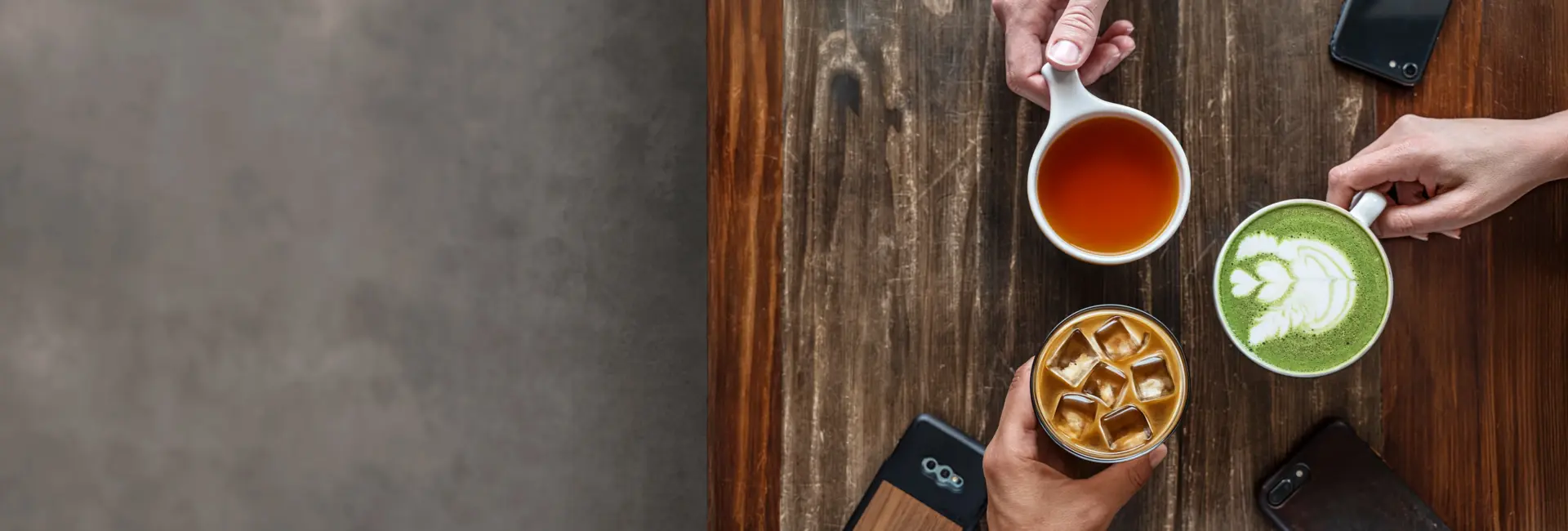 group of people sitting at a table with cups of tea