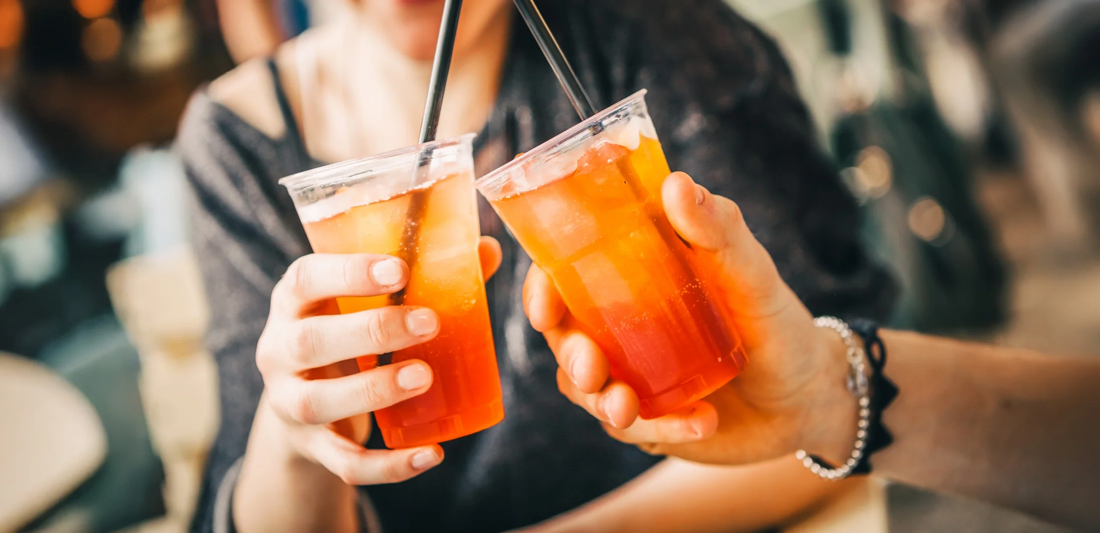 woman holding two beverages in her hands