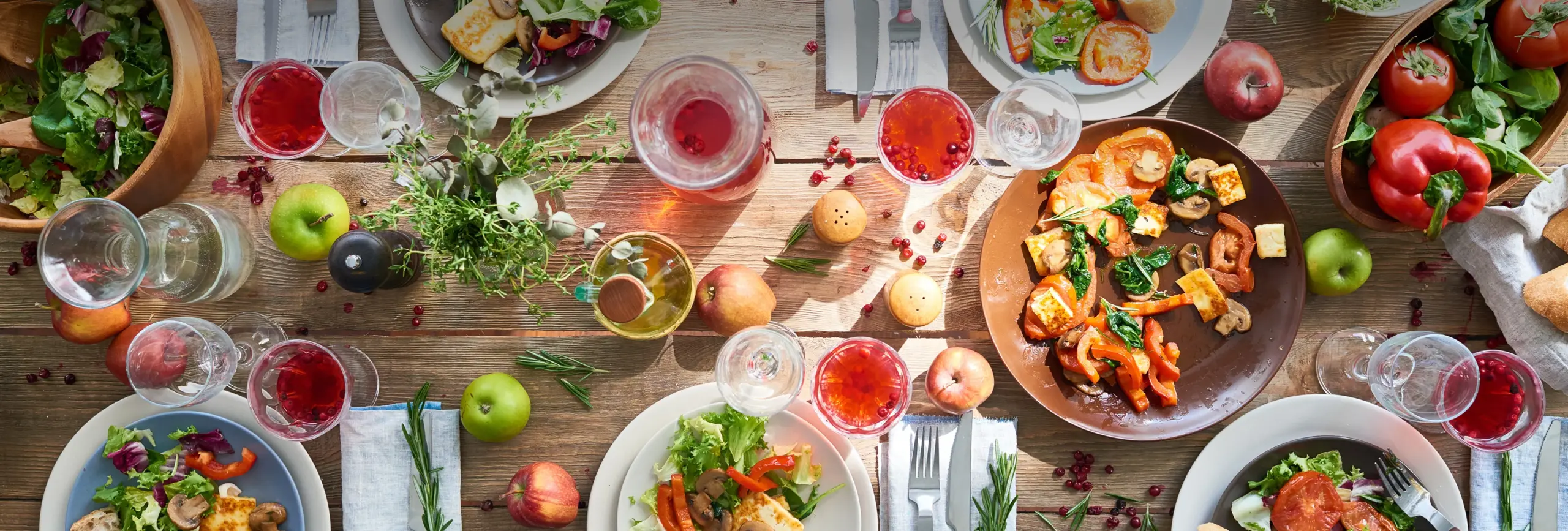 table topped with lots of plates of food and beverages